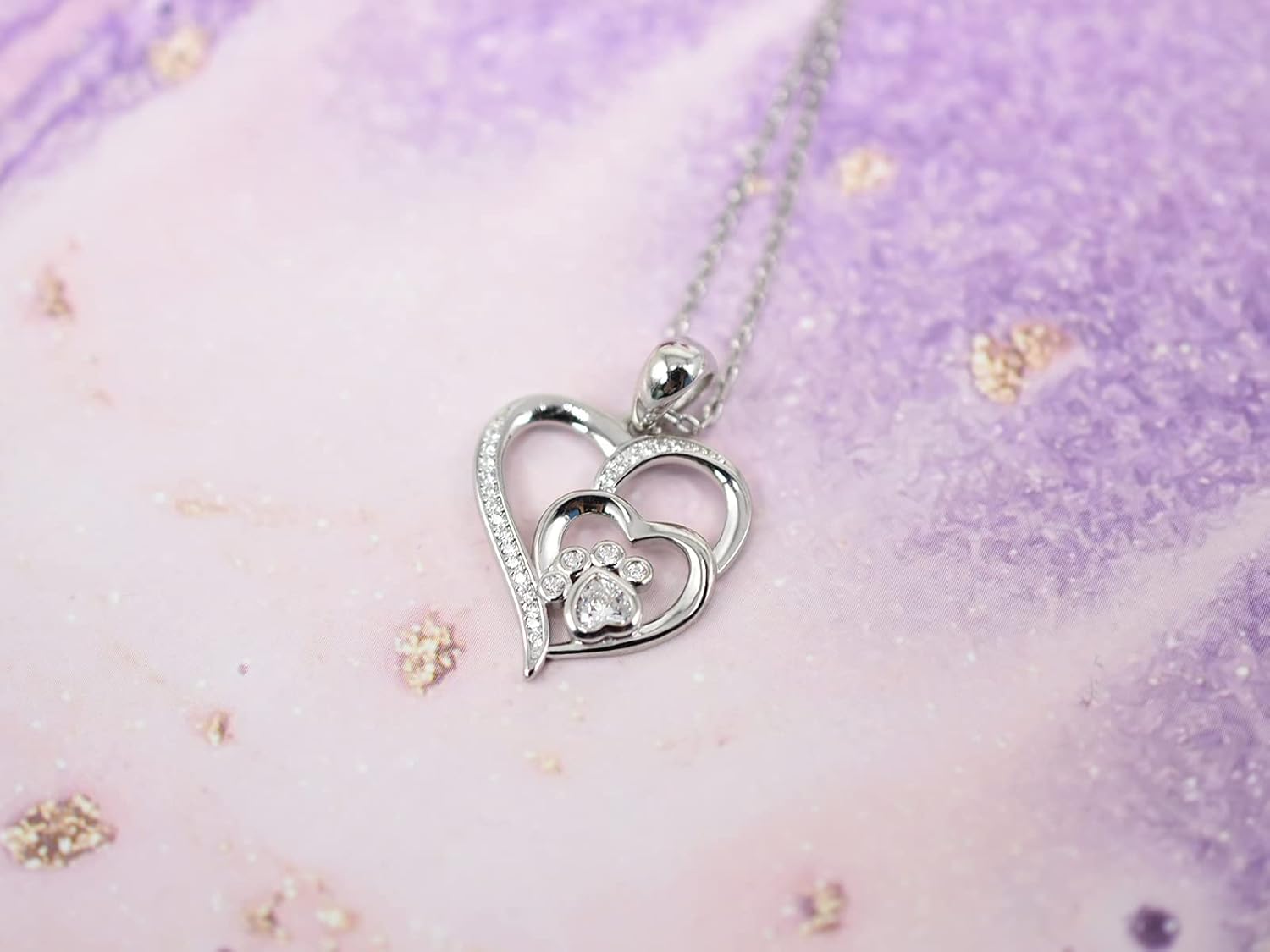 Sterling silver necklace with paw print and heart, set with zirconia.