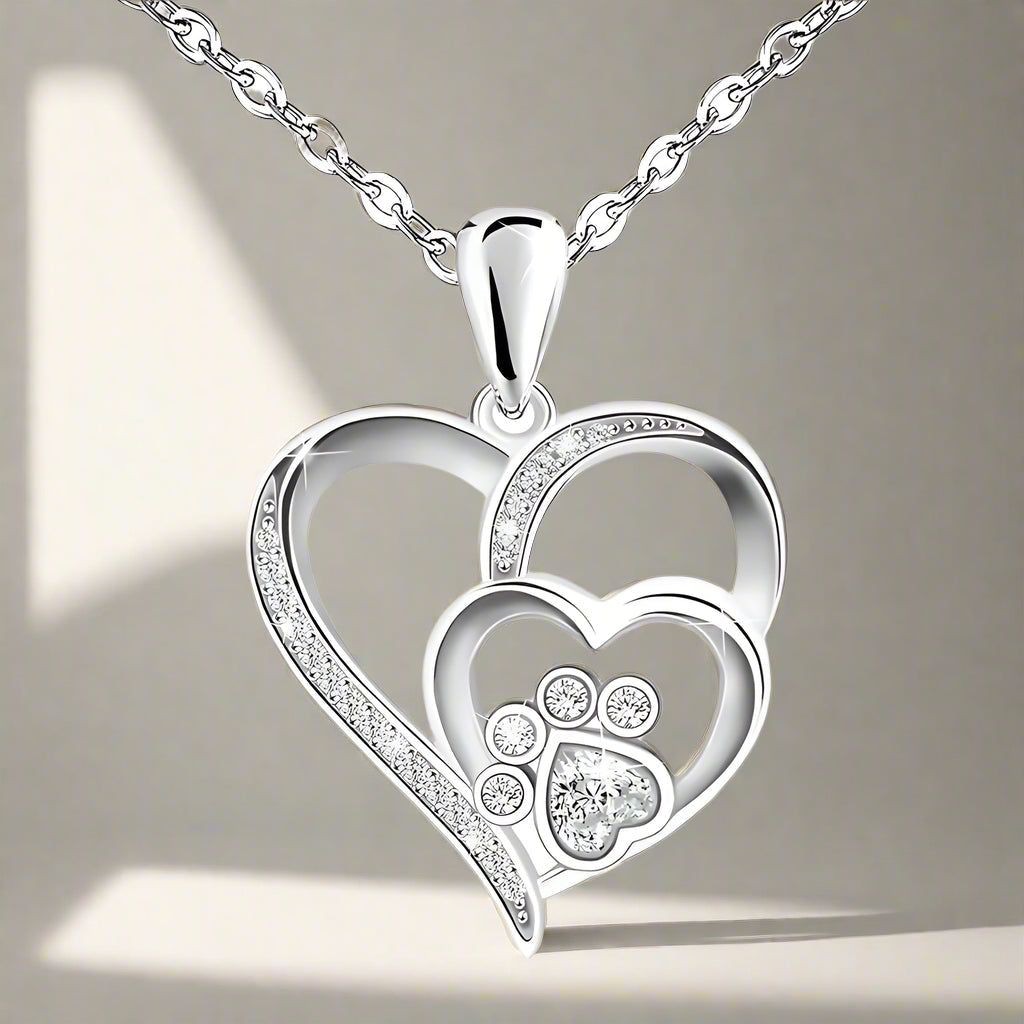 Sterling silver necklace with paw print and heart, set with zirconia.